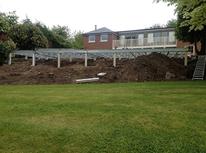 AB Sundecks huge subframe behind house in the garden